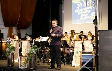 Mężczyzna z mikrofonem na scenie.