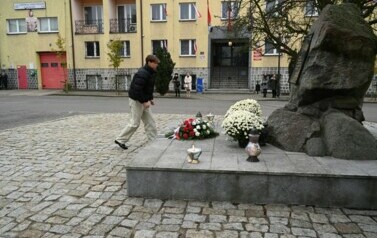 Przewodniczący Rady Młodzieży składa znicz na pomnik 
