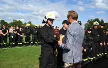 Burmistrz wręcza przedstawicielowi drużyny strażackiej Gołaszewo puchar za zajęcie pierwszego miejsca