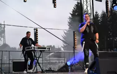 widzimy pana, kt&oacute;ry śpiewa oraz drugiego pana w tle