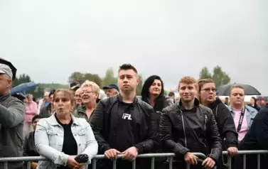 widzimy dużą grupę os&oacute;b słuchającą koncertu