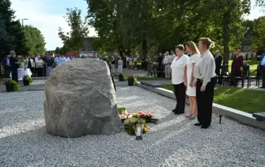widzimy trzy panie stojące na baczność przed pomnikiem