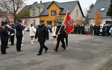 widzimy orkiestre oraz grupe dziewczyn z pomponami oraz idącą grupe ze sztandarami