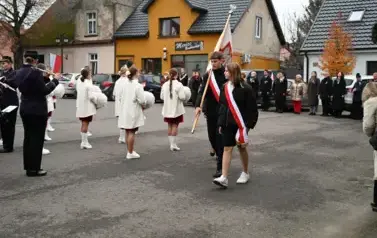 widzimy orkiestre oraz grupe dziewczyn z pomponami oraz idącą grupe ze sztandarami