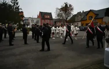 widzimy orkiestre oraz grupe dziewczyn z pomponami oraz idącą grupe ze sztandarami