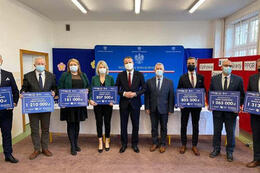 Na zdjeciu widać włodarzy gmin trzymających w rękach promesy z kwotami jakei zostały przyznane poszczeg&oacute;lnym gminom. 